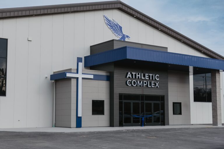 Athletic Complex building with a cross logo and an eagle emblem