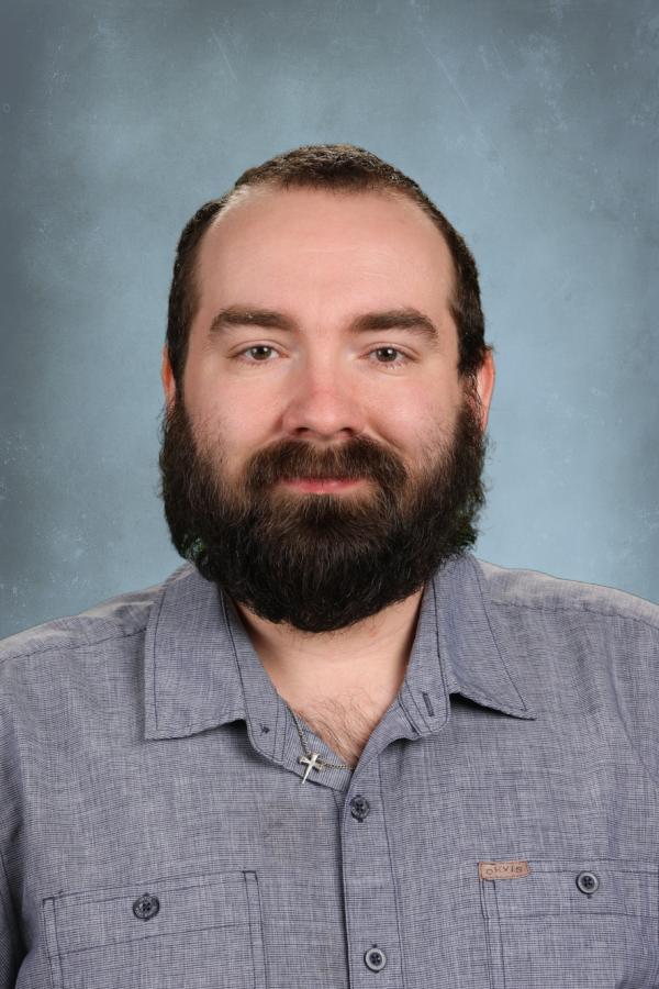 Man with beard wearing a blue button-down shirt