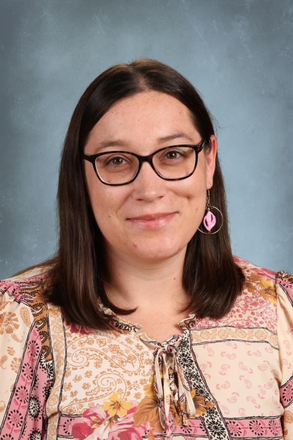 Woman with glasses and floral shirt