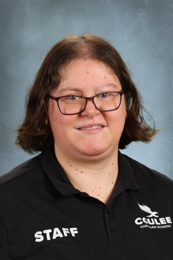 Caulee Christian School staff member wearing a black polo with "STAFF" and school logo.