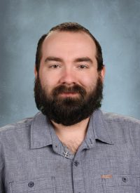 Man with beard wearing a blue button-down shirt