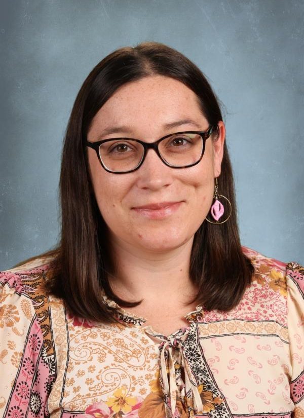 Woman with glasses and floral shirt