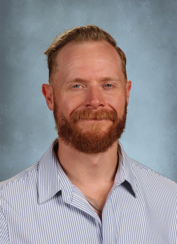 Man with red beard and blue eyes wearing a striped shirt